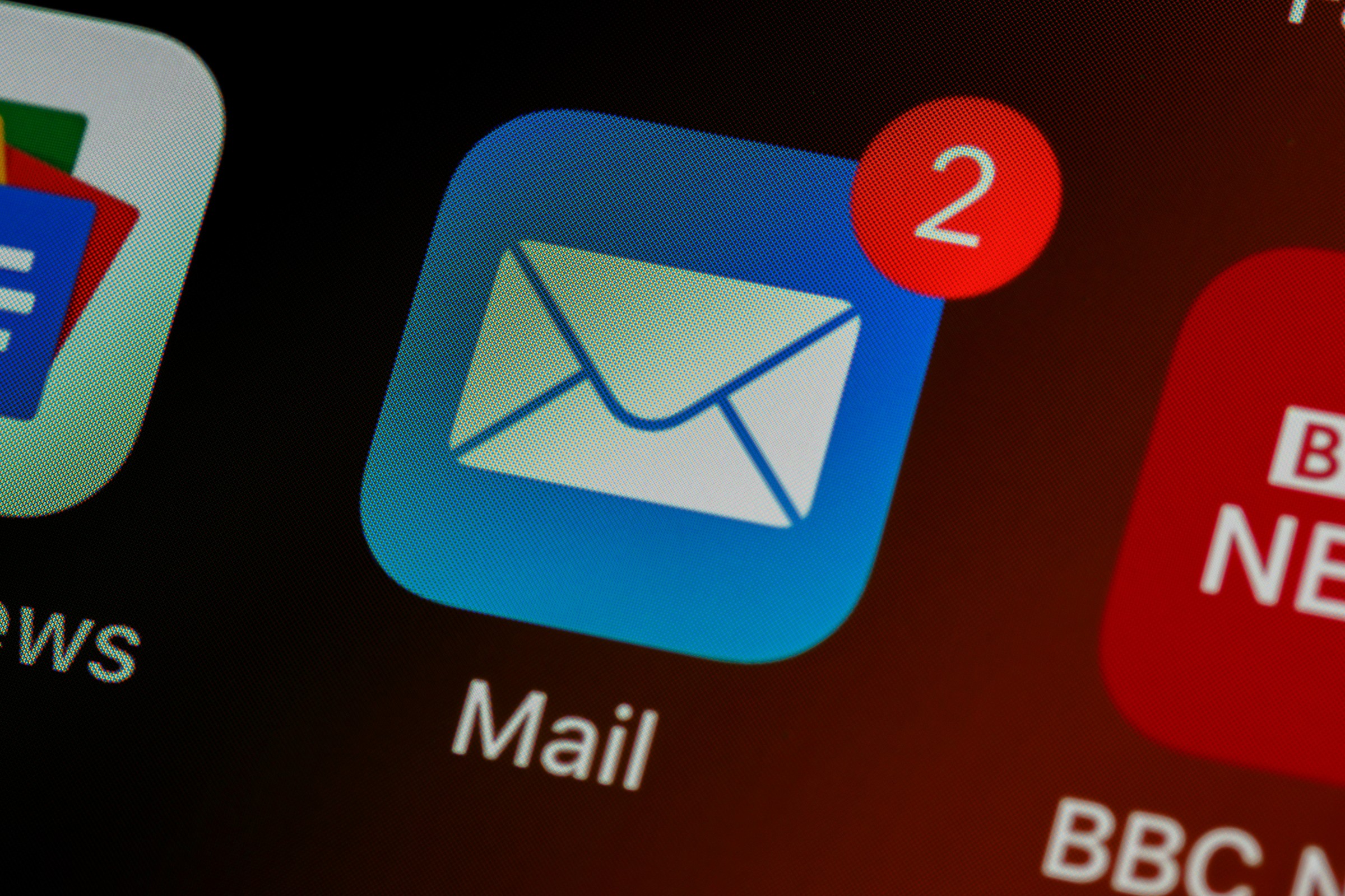 Email app icon with new message notification on mobile screen, representing incoming ecommerce emails.