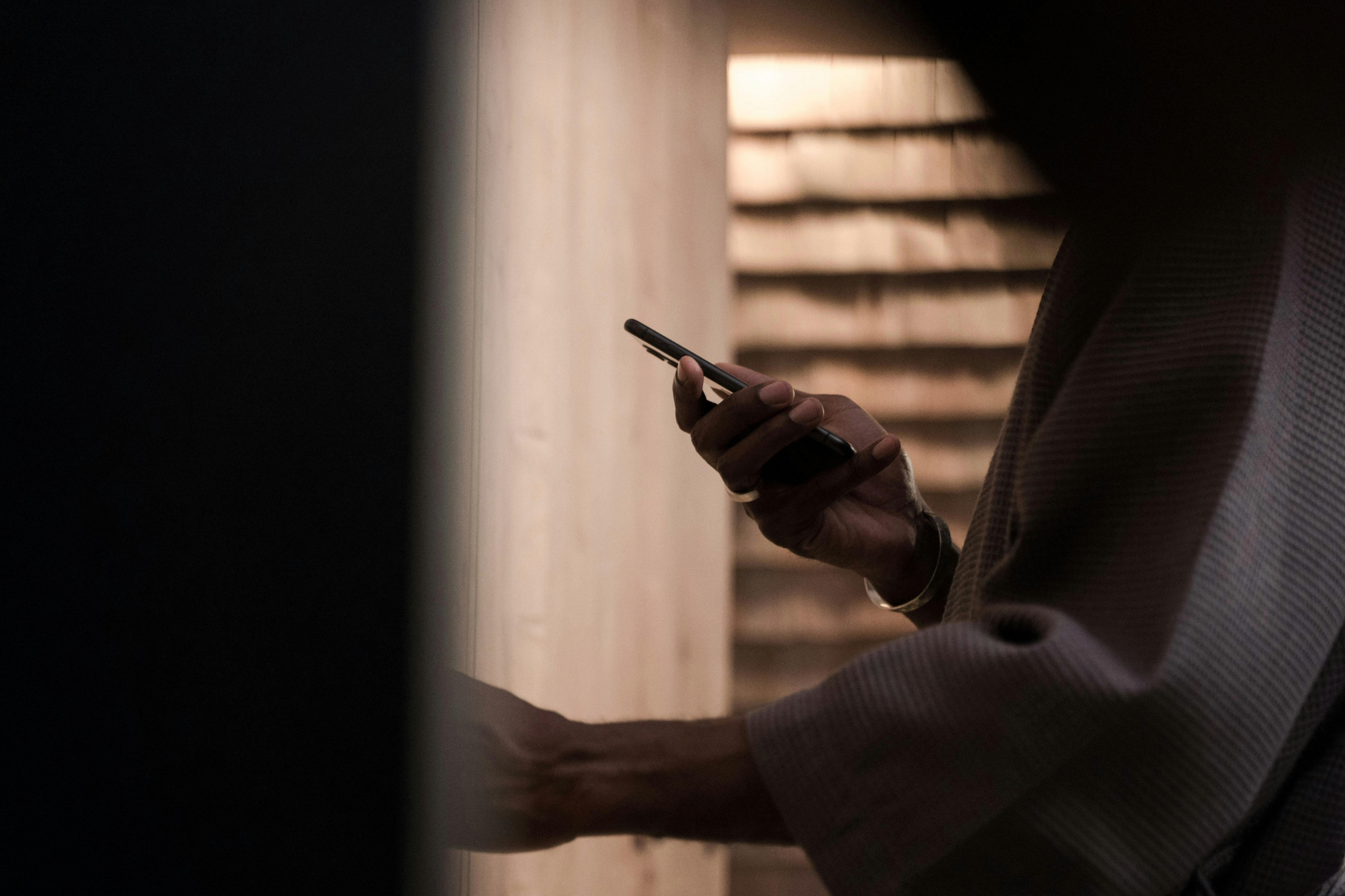 Close-up of a person holding a smartphone, highlighting real mobile shopping behavior.
