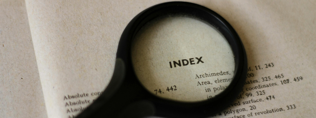 Magnifying glass highlighting the word Index, symbolizing keyword discovery and customer search patterns.