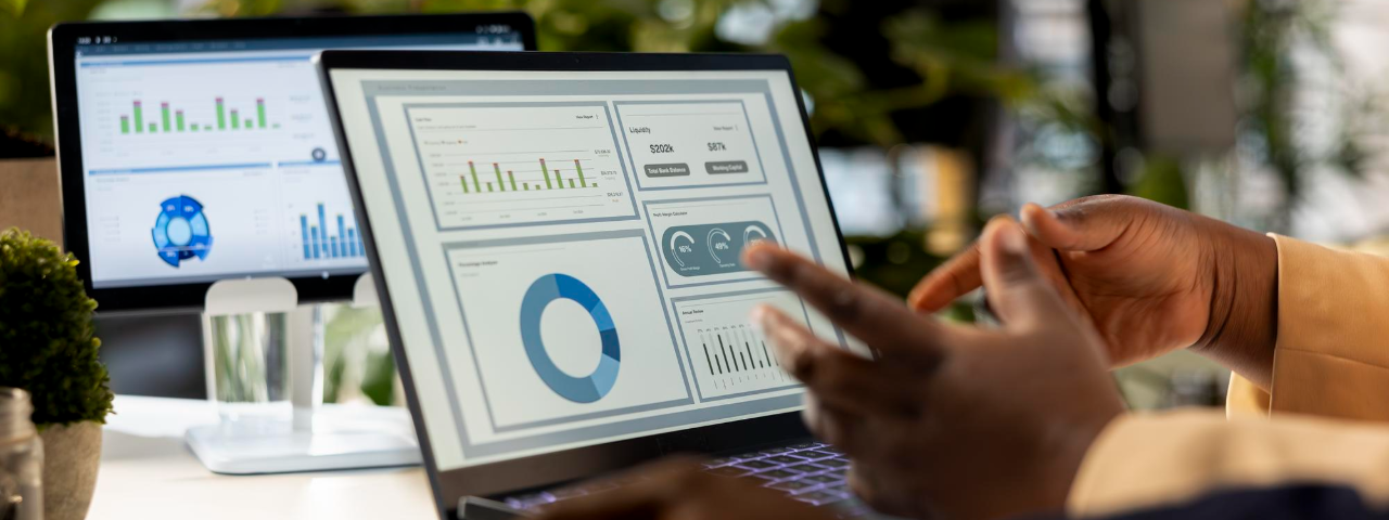 Professional analyzing analytics dashboards on laptop screens, reviewing performance metrics and business data.