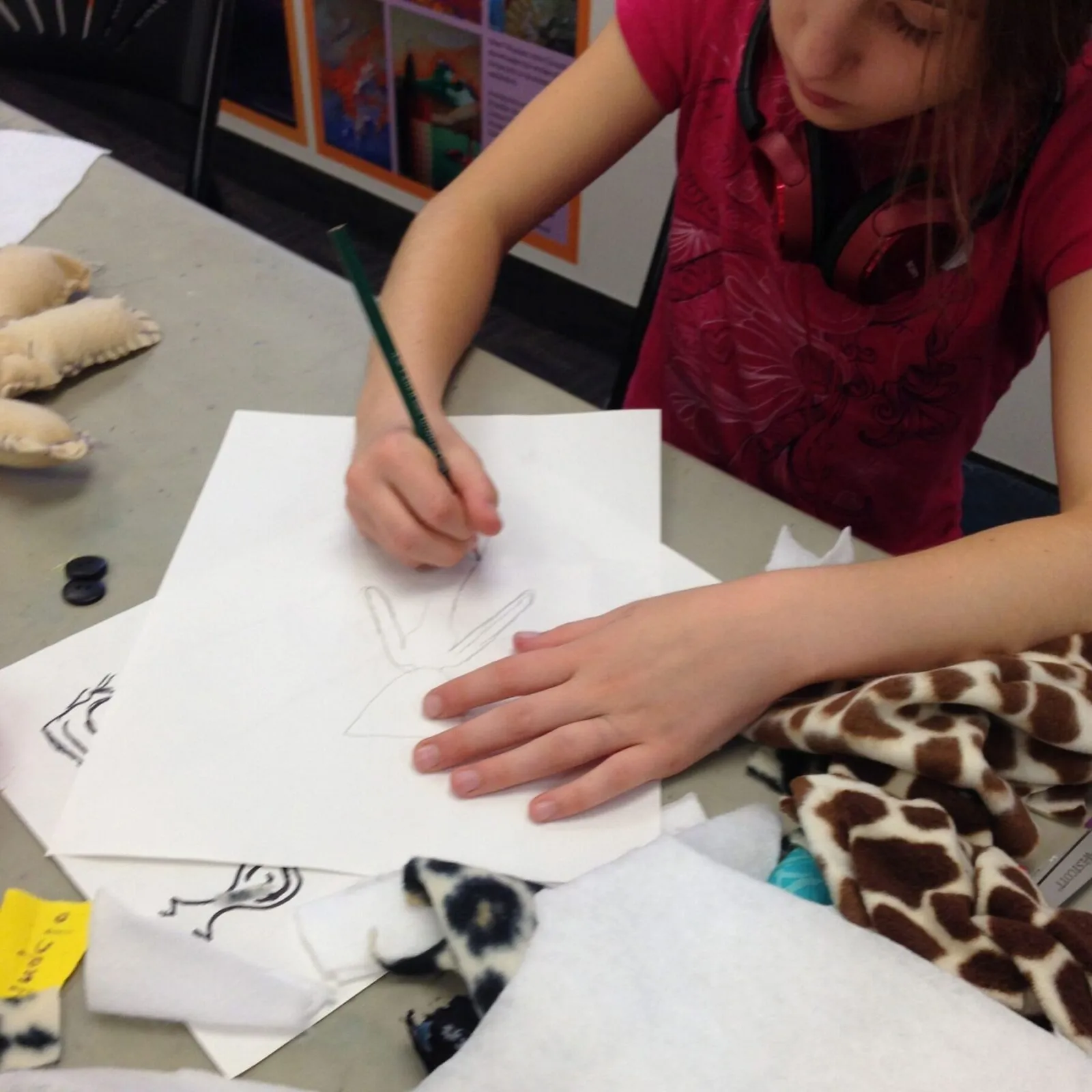 Girl drawing on paper with pencil