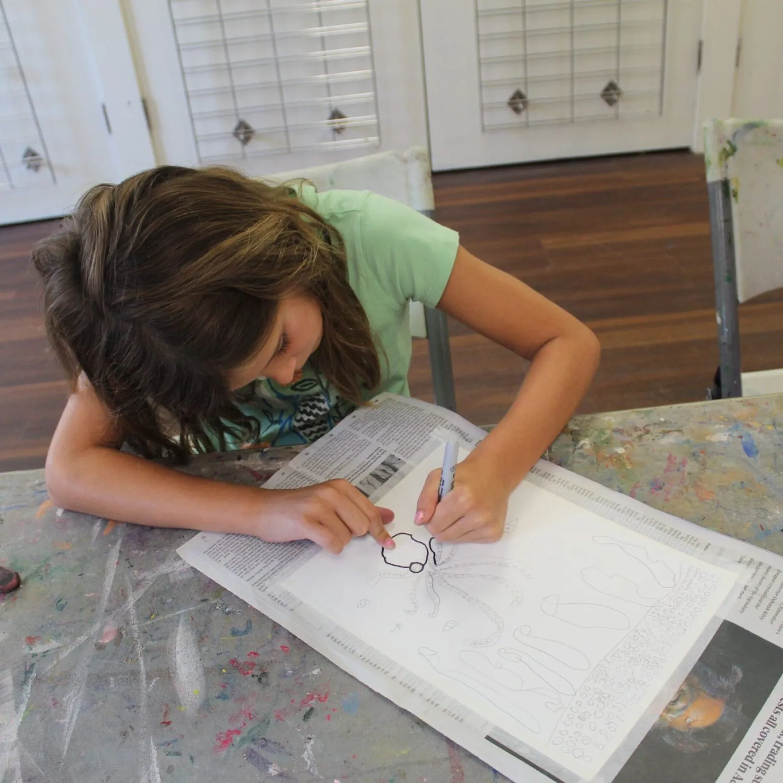 girl traces drawing with sharpie