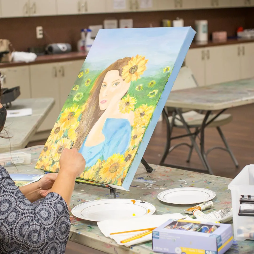 painting of a woman in sunflowers