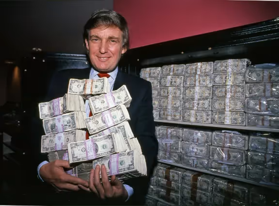 A person holding a large stack of moneyAI-generated content may be incorrect.