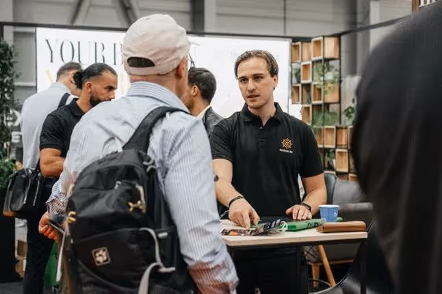 A group of men standing around a tableAI-generated content may be incorrect.