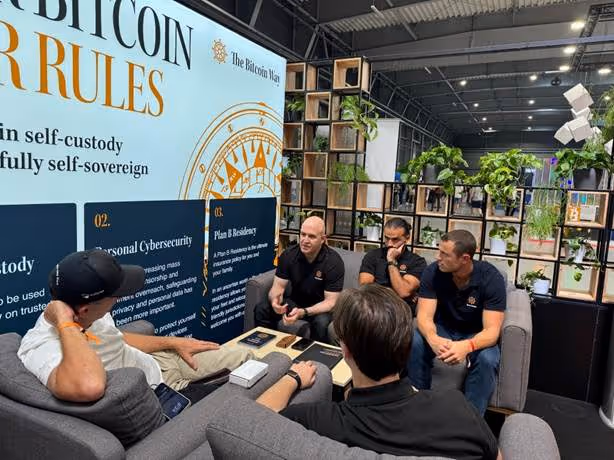 A group of men sitting in a roomAI-generated content may be incorrect.