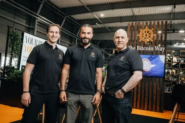 A group of men standing in a roomAI-generated content may be incorrect.