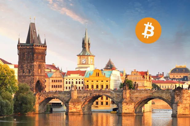 A bridge over water with a large clock tower and a large clock towerAI-generated content may be incorrect.