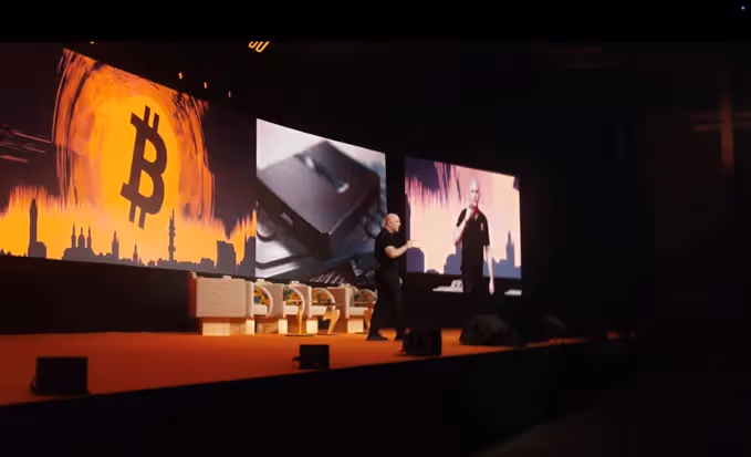 A person on a stage with large screensAI-generated content may be incorrect.