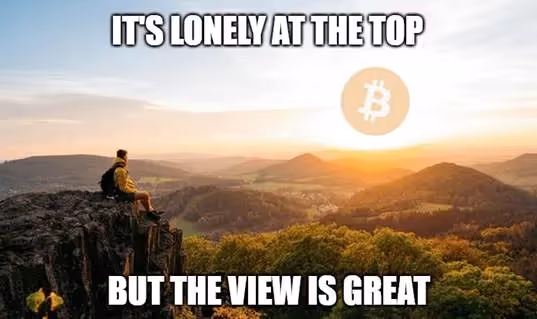 A person sitting on a cliff looking at a landscapeAI-generated content may be incorrect.
