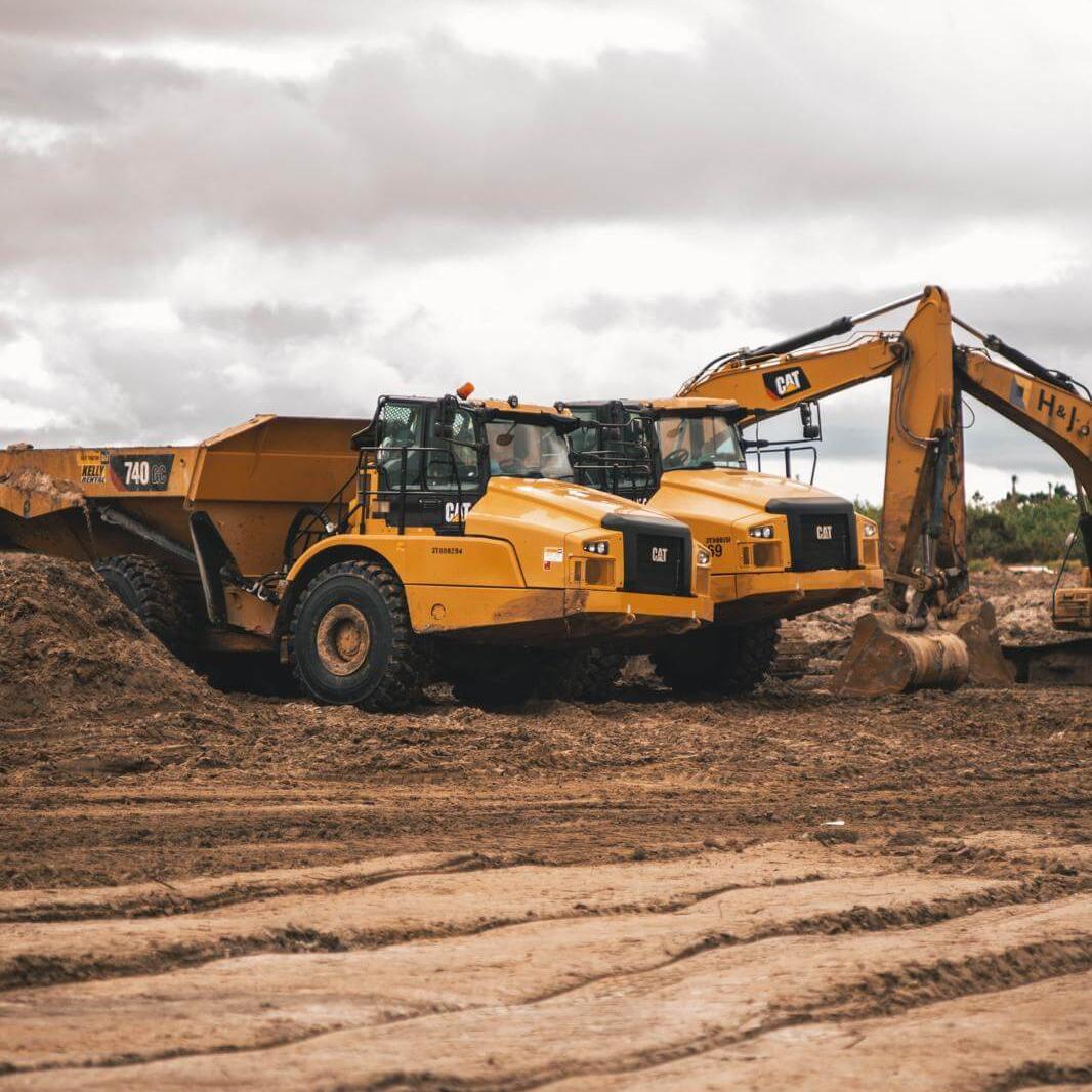 yellow and black heavy equipment on brown soil
