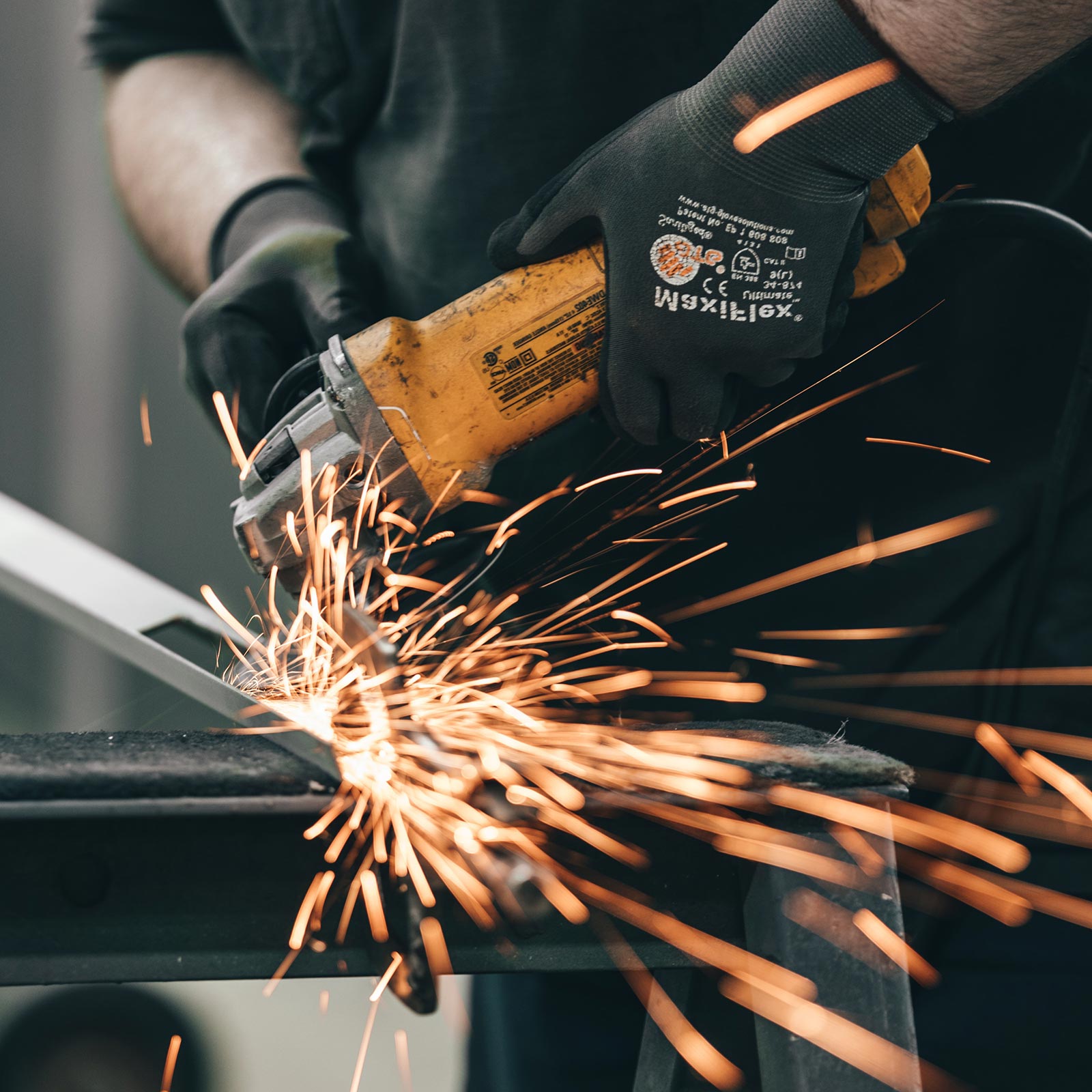 a man using a grinder on a piece of metal