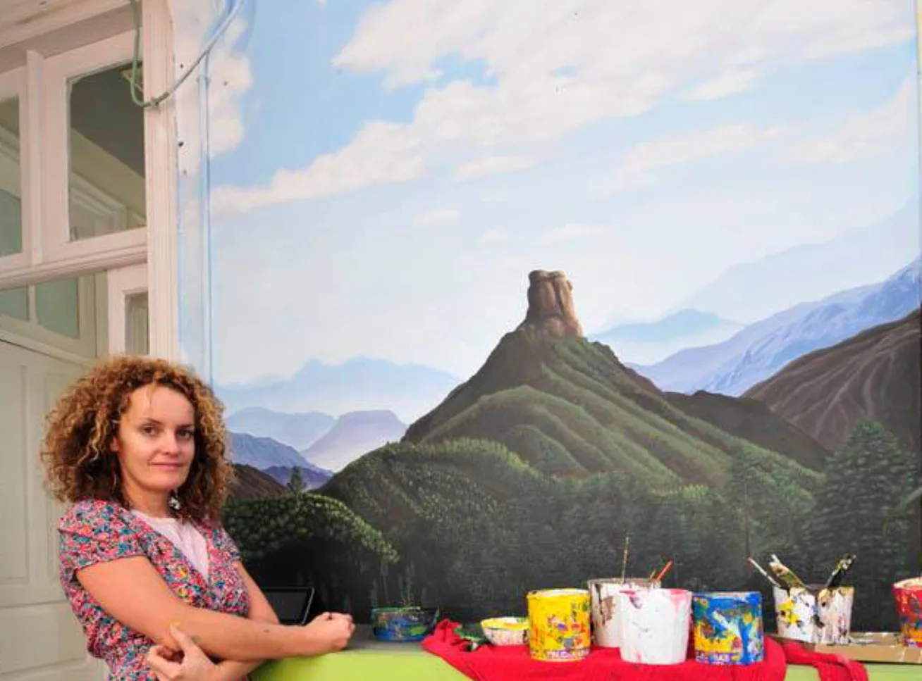 a painter woman with her mural - mountains of the center of Gran Canaria island