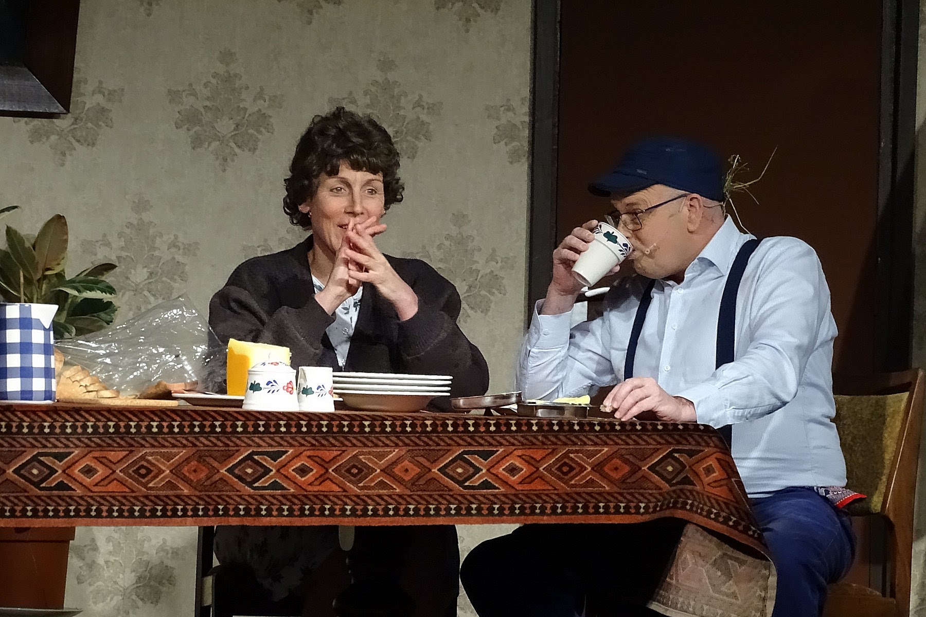 Burger with fried fries on black plate with sauce on the side