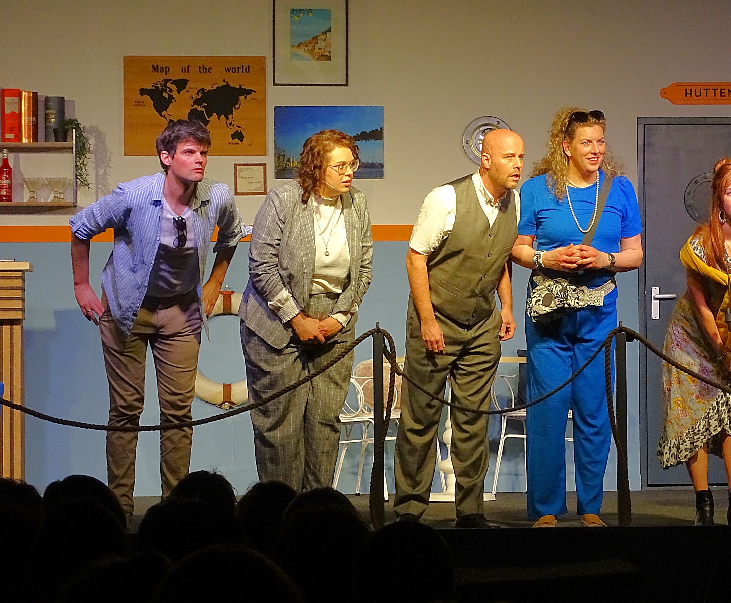 Burger with fried fries on black plate with sauce on the side