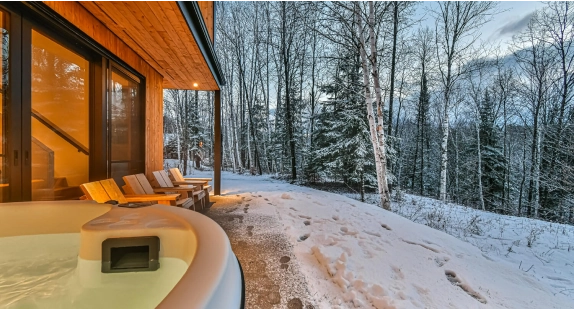 A cottage with a hot tub.