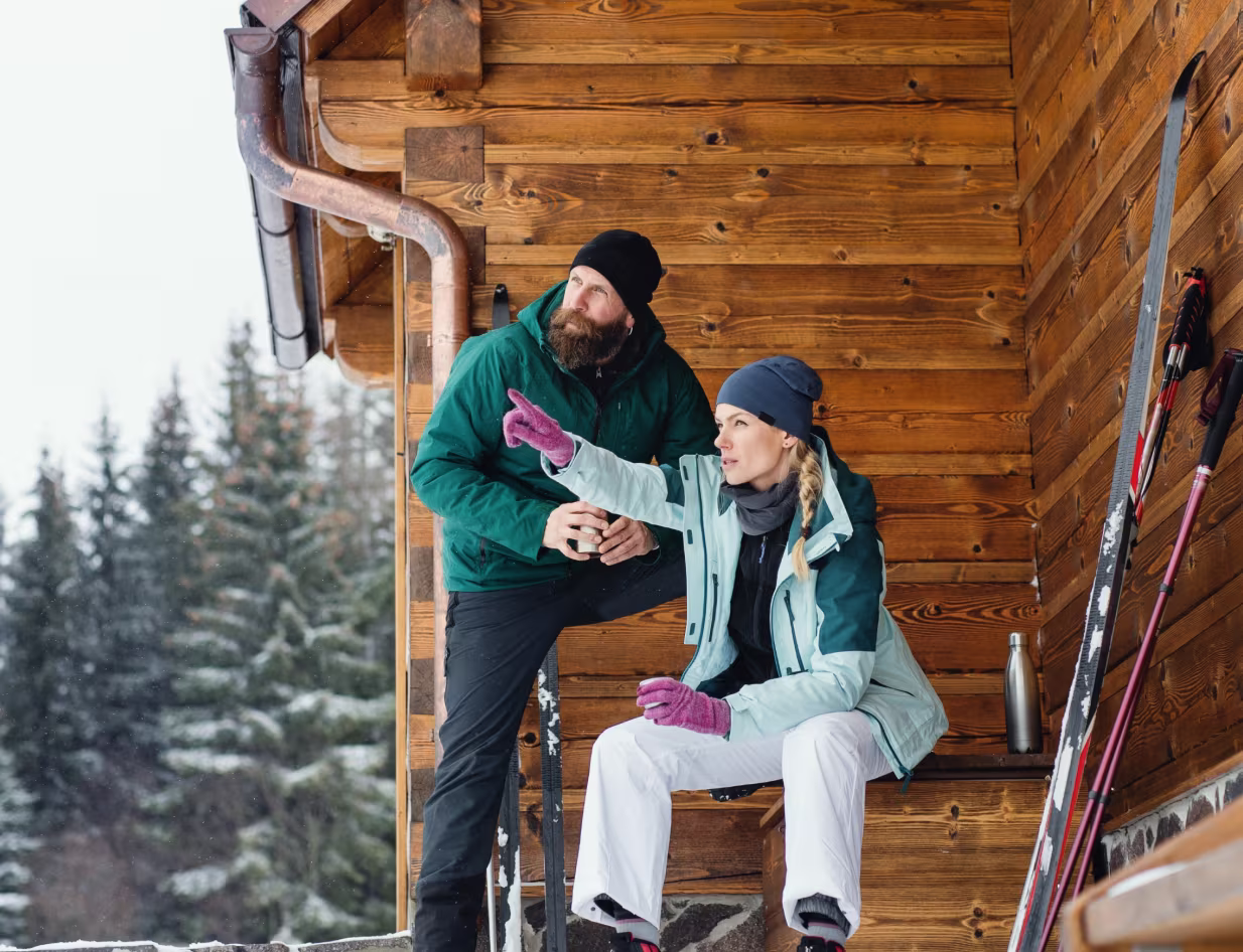 Image of a multi-story building with a light blue facade and a stone wall in Mont-Tremblant
