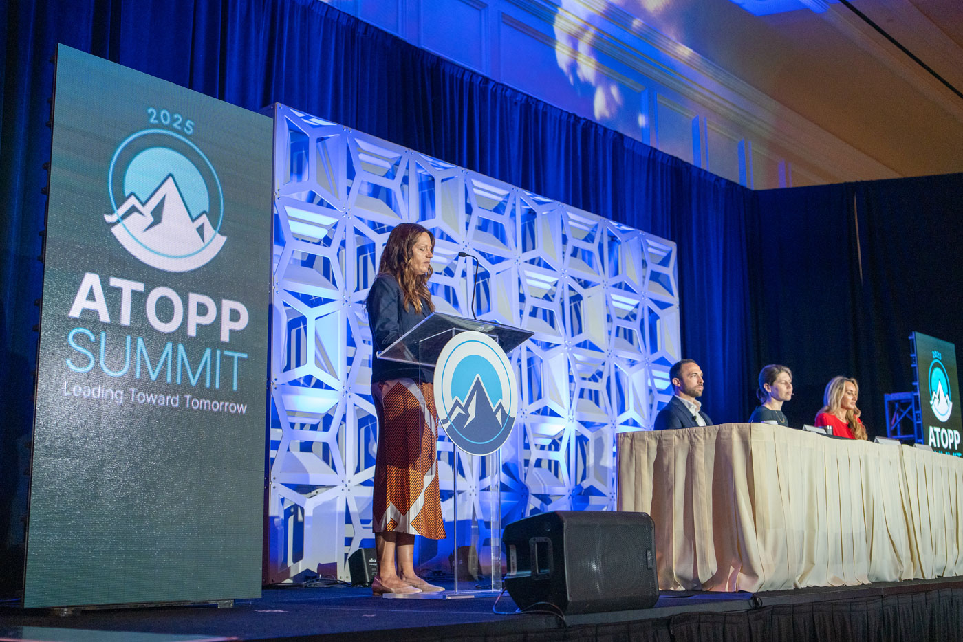 Image of audience watching speaker at conference