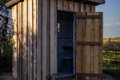 Wooden outdoor outhouse.