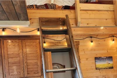 Wooden ladder leading to loft.