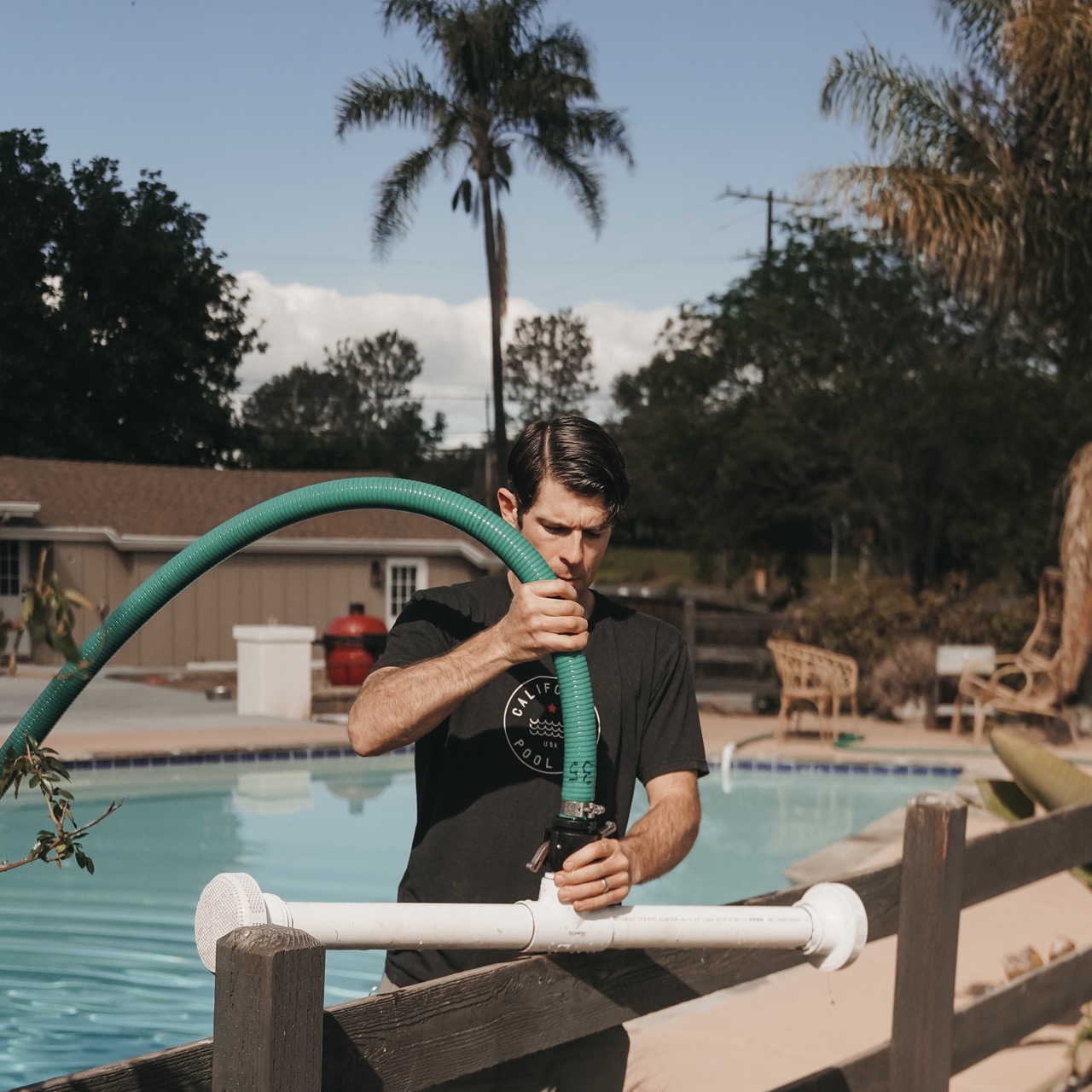 Man adjusts reverse osmosis pool water purification equipment.