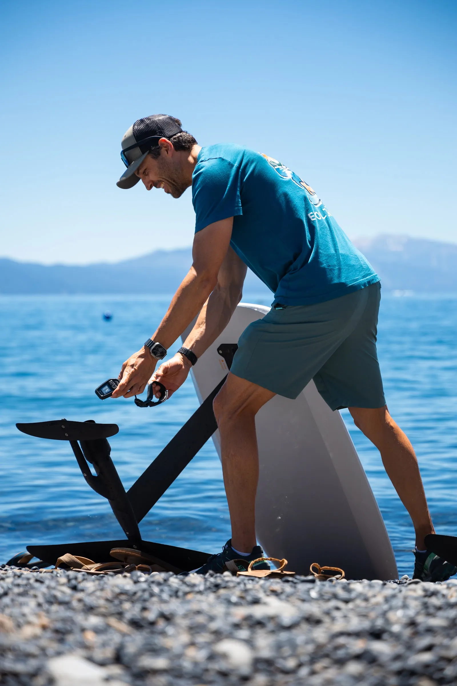 Efoil Tahoe instructor holding a Fliteboard controller during the equipment briefing on the shore of Lake Tahoe