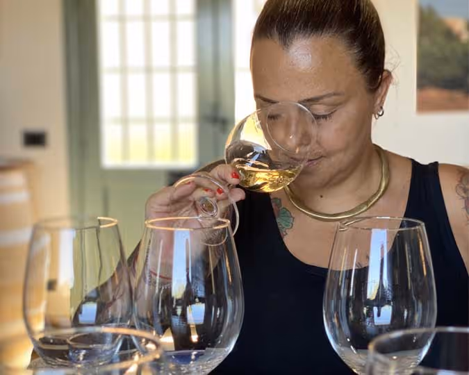 a woman smelling wine