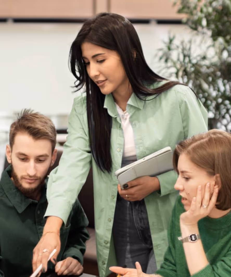 A woman stands confidently before a group, embodying a strong commitment to customer service and engagement.