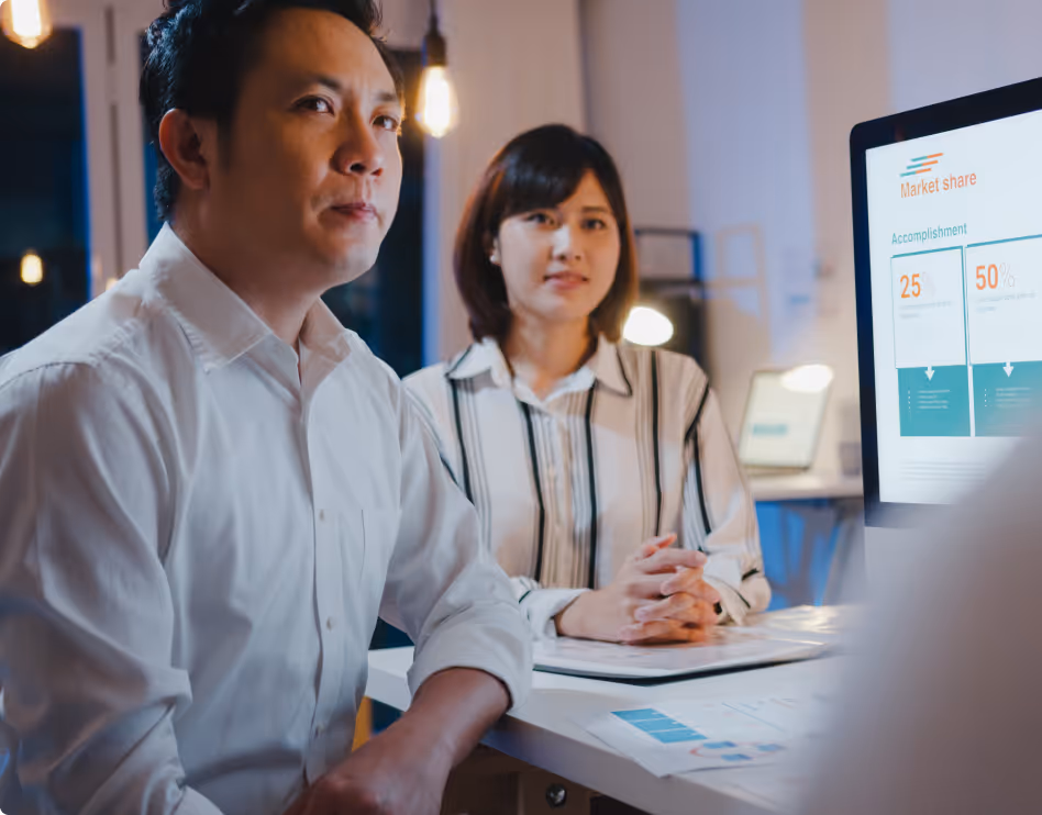 Asian men and women engaged in a consultation, representing the concept of NetSuite customization for business solutions.