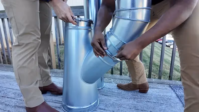 2 Duct Guys clamping together duct. 