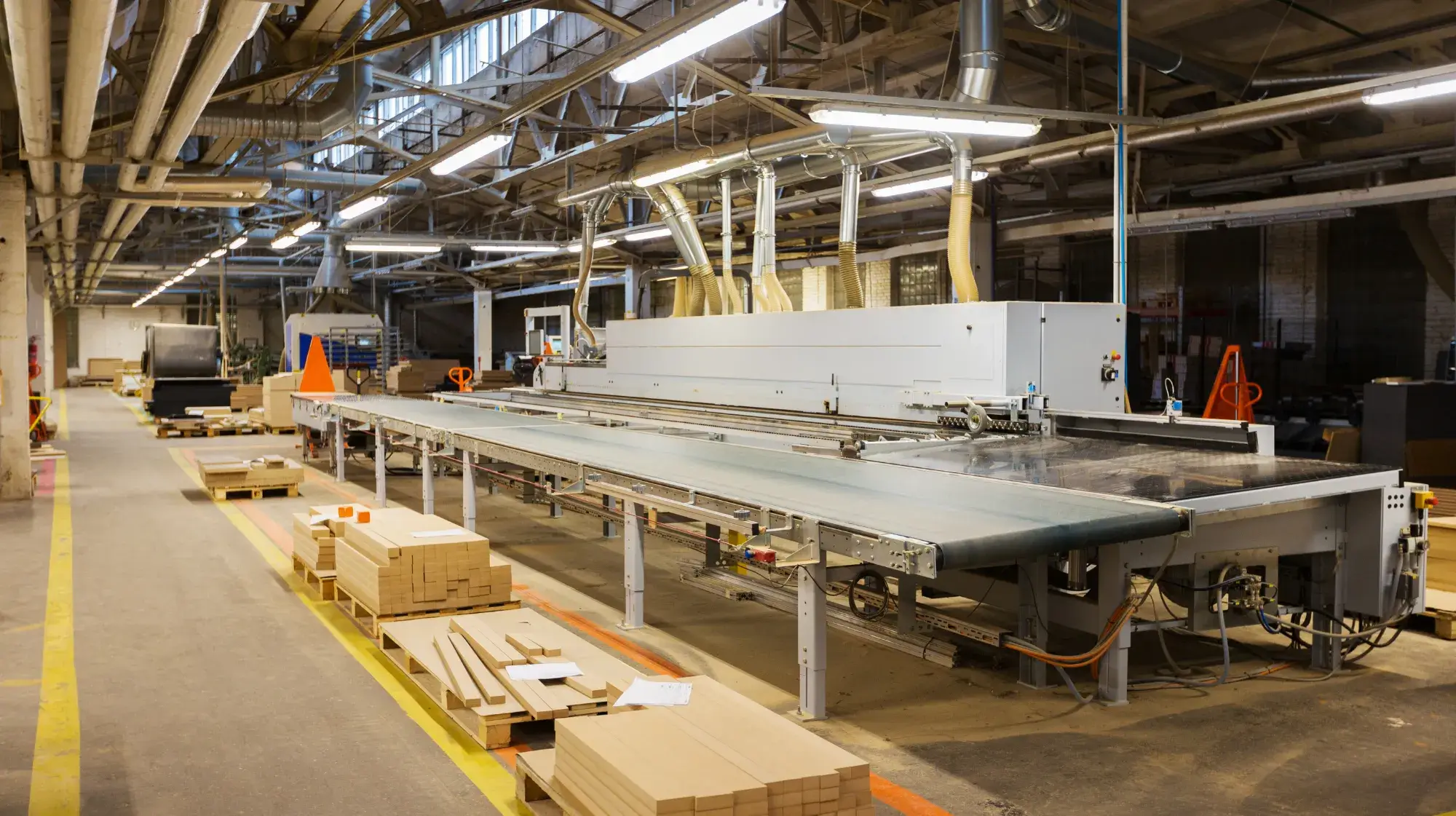 Factory interior with dust collection system controlling air quality, keeping the industrial workshop clean, safe, and efficient.