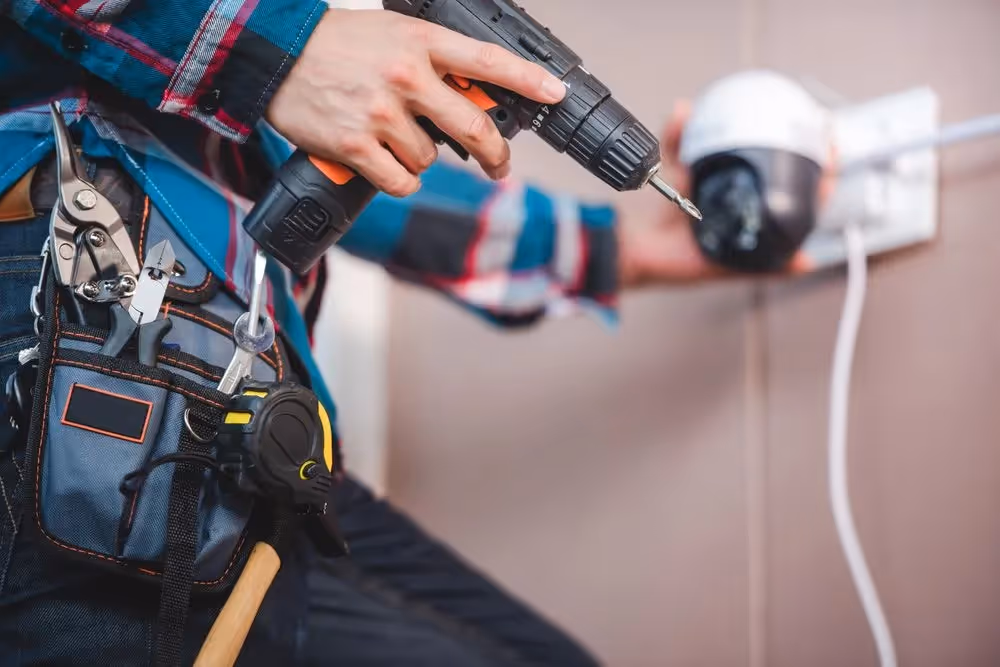 Man installing a security camera