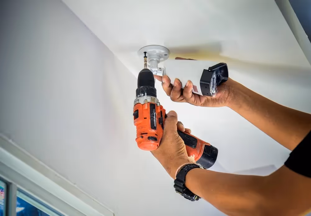 Man installing a security camera