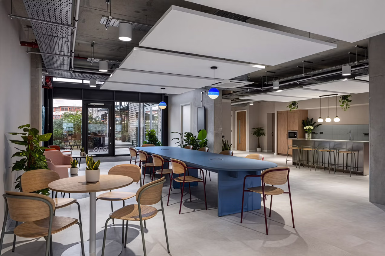 Bespoke pill shaped slab table in lacquered veneer in a cafe setting 