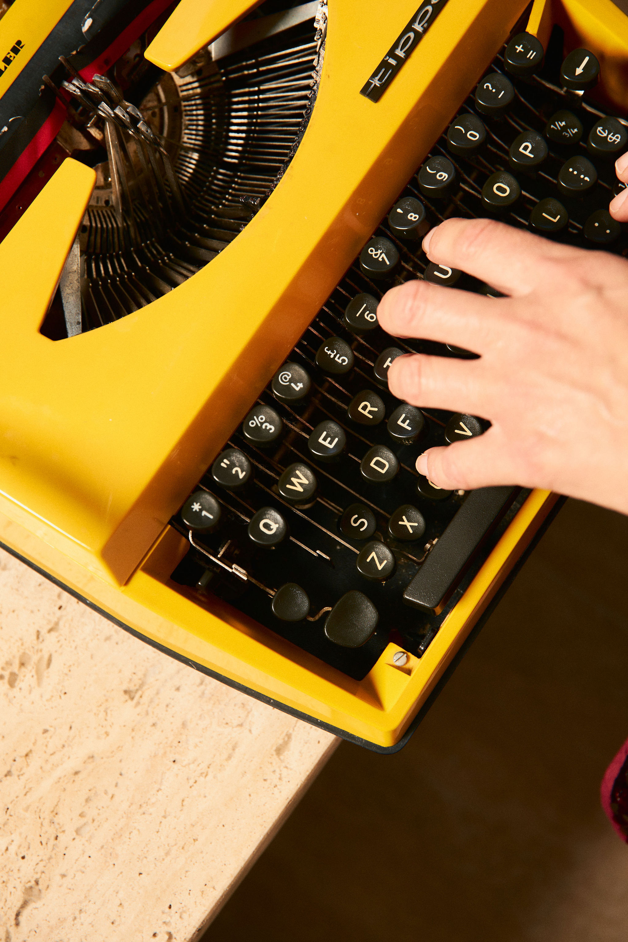 Vintage yellow typewriter during a brand photography session.