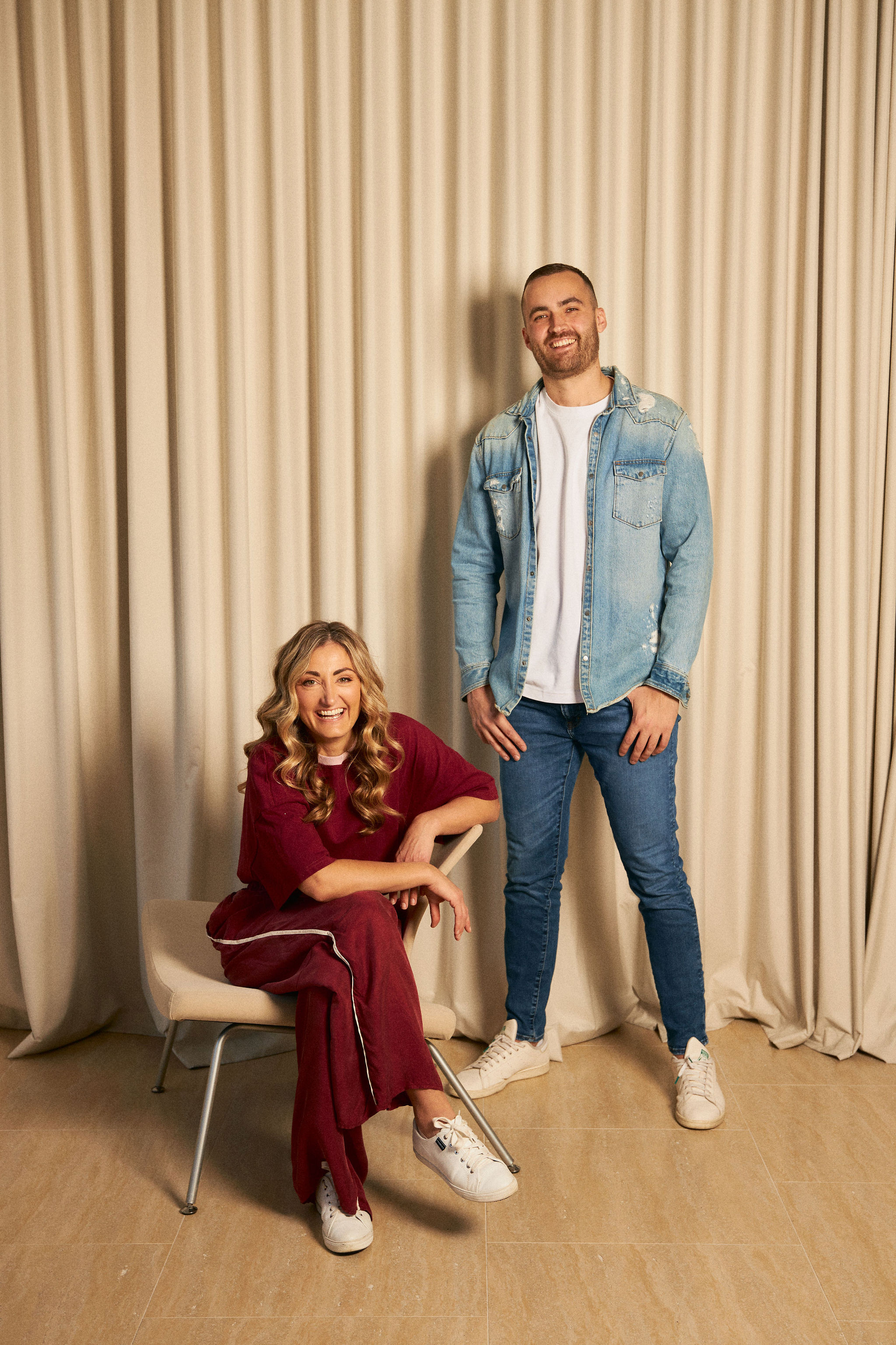 A man and woman posing confidently during a brand photography session.