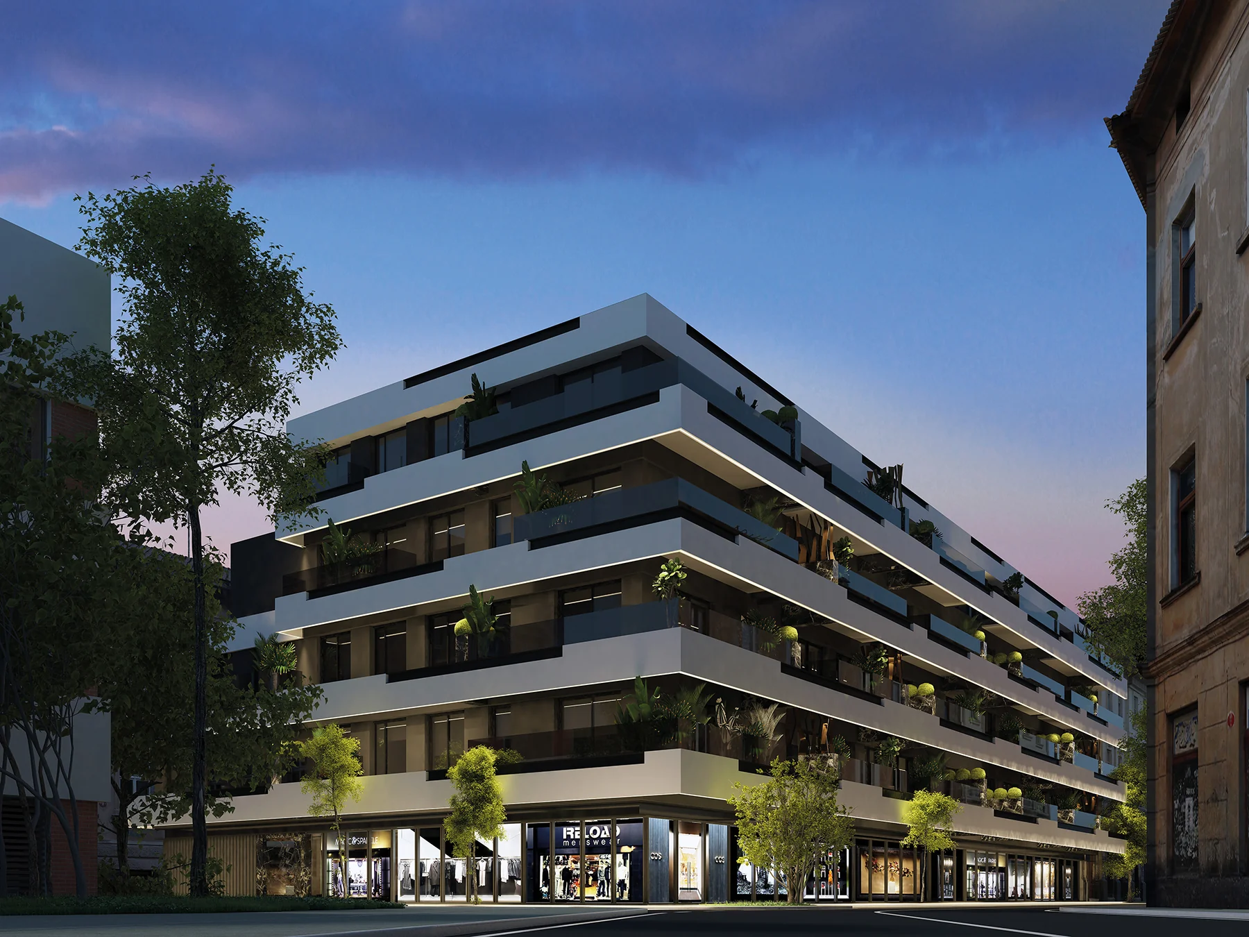 Dusk rendering of a corner apartment building with horizontal white balcony bands and greenery, ground-floor shopfronts lit along the street corner – Edificio España, a 3-bedroom apartment in Av. Condes de San Isidro, 52, 29640 Fuengirola, Málaga