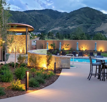 Ravenna Golf Club clubhouse exterior with architectural lighting and Colorado foothills at dusk