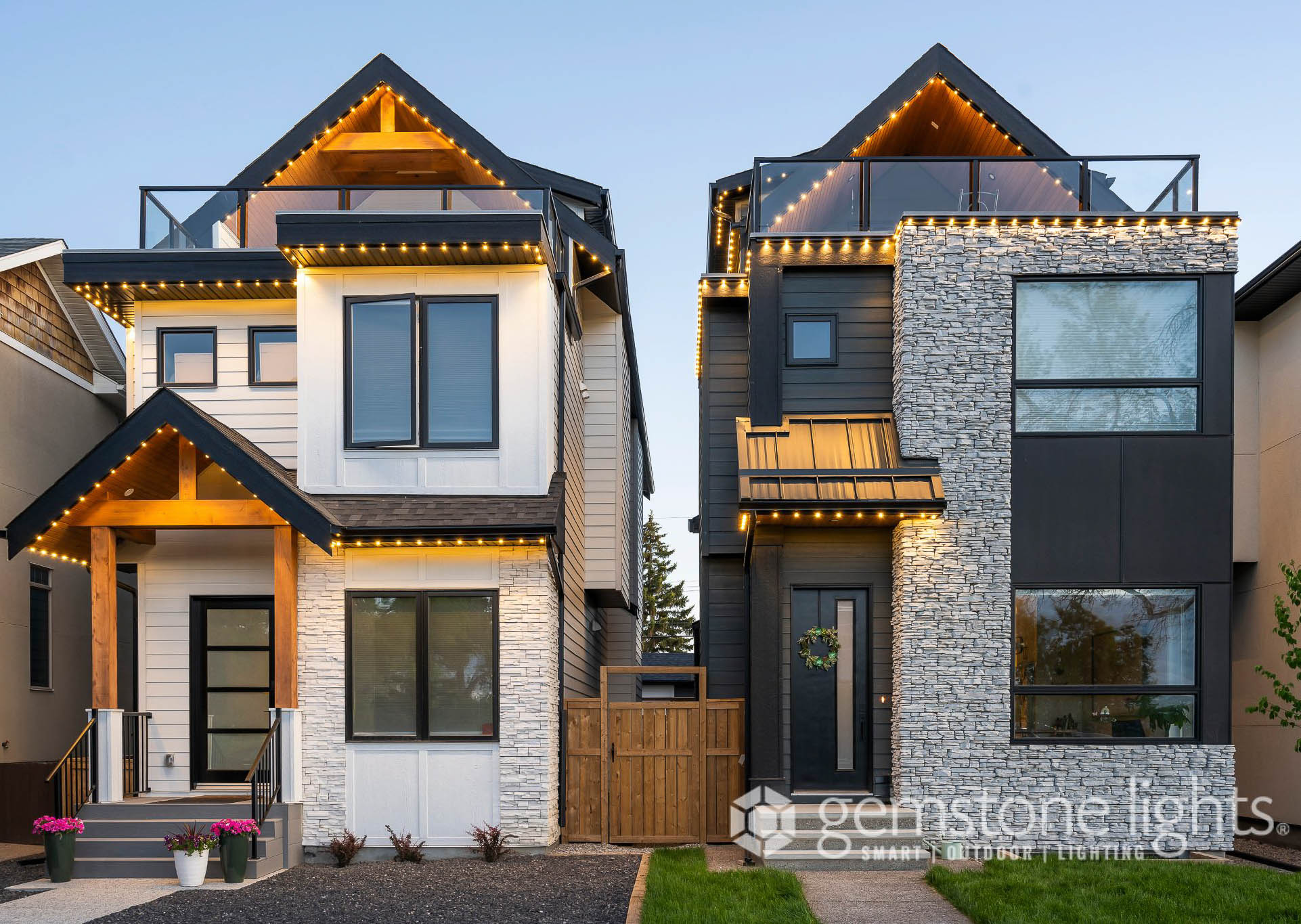 Permanent LED roofline lighting on modern infill homes at dusk