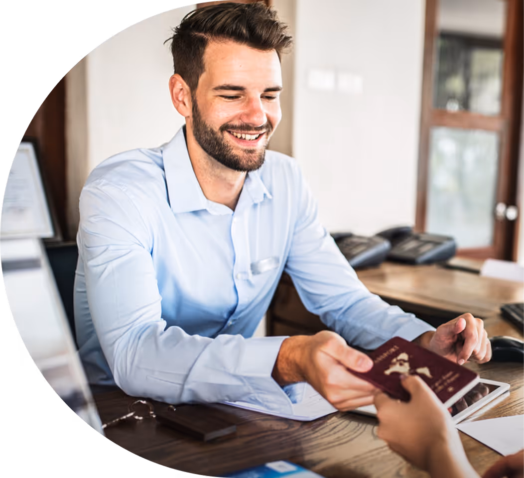 Businessman taking someones passport over an office desk