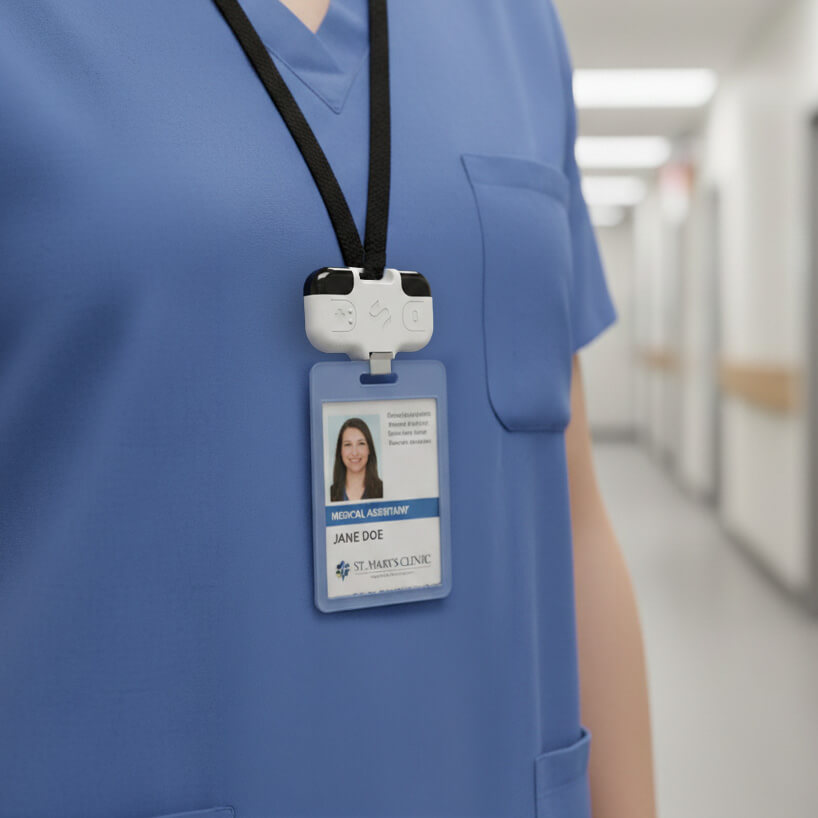 Medical assistant wearing blue scrubs with a badge labeled Jane Doe from St. Mary’s Clinic attached to a black lanyard.