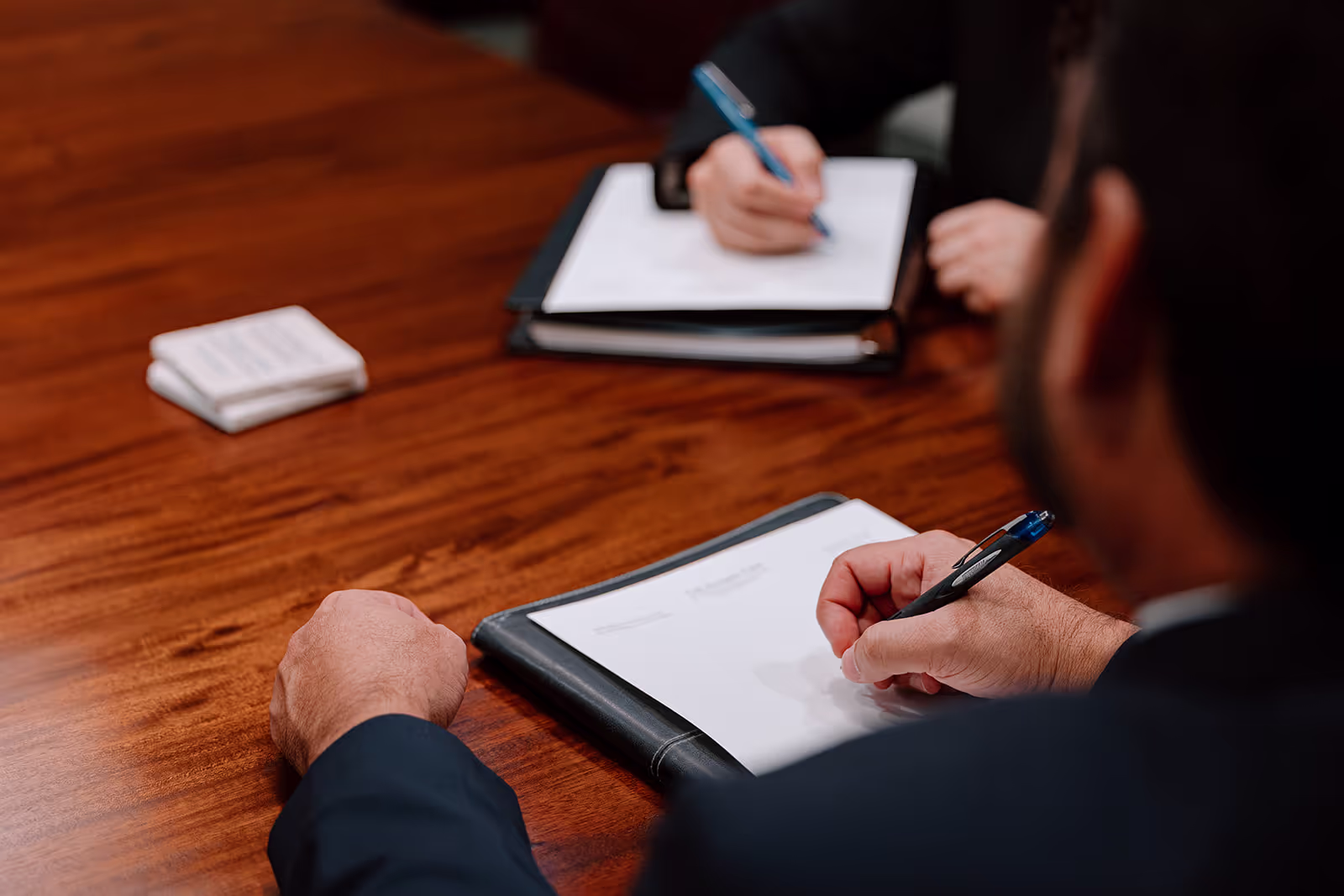 Attorneys writing during meeting