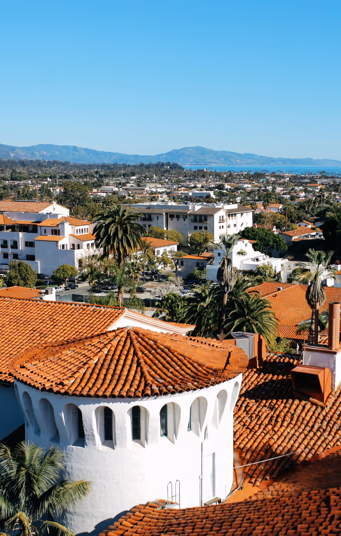 Beautiful rooftop view of a Californian city, with ridges and the ocean in the distance