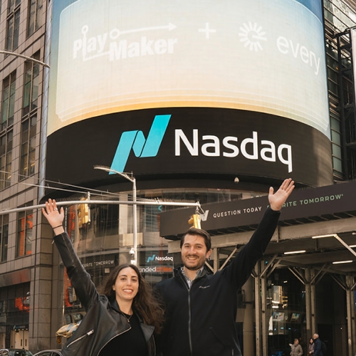 Image of Hannah and Sammy in front of the NASDAQ billboard for an advertisement with PlayMaker and Every.io