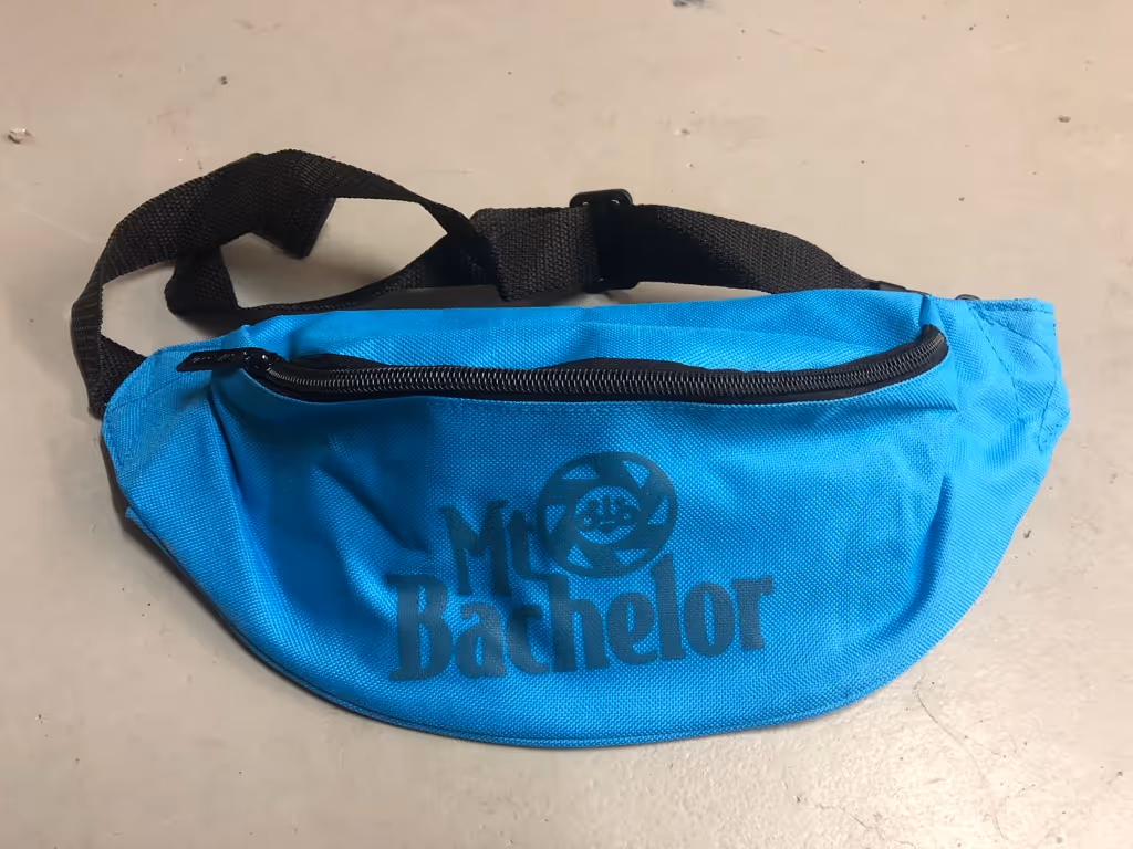 A blue bag sitting on top of a white floor.