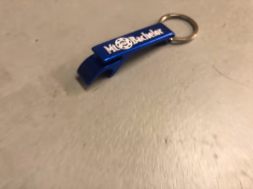 A blue bottle opener sitting on top of a table.