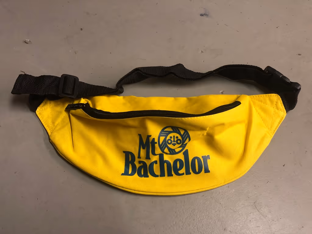 Yellow fanny pack with "Mt Bachelor" printed in black.