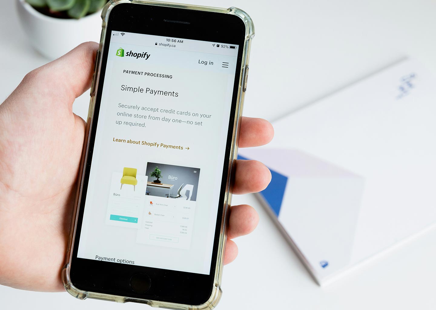 A user browses an online store using hand held cell phone.