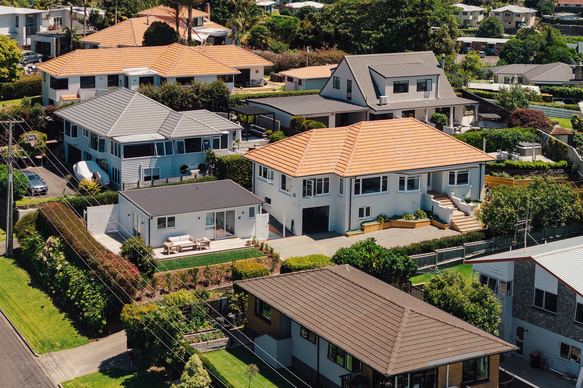 Aerial view of Judea residential neighbourhood in Tauranga showing houses with terracotta tile roofs near Gardo Group minor dwelling project
