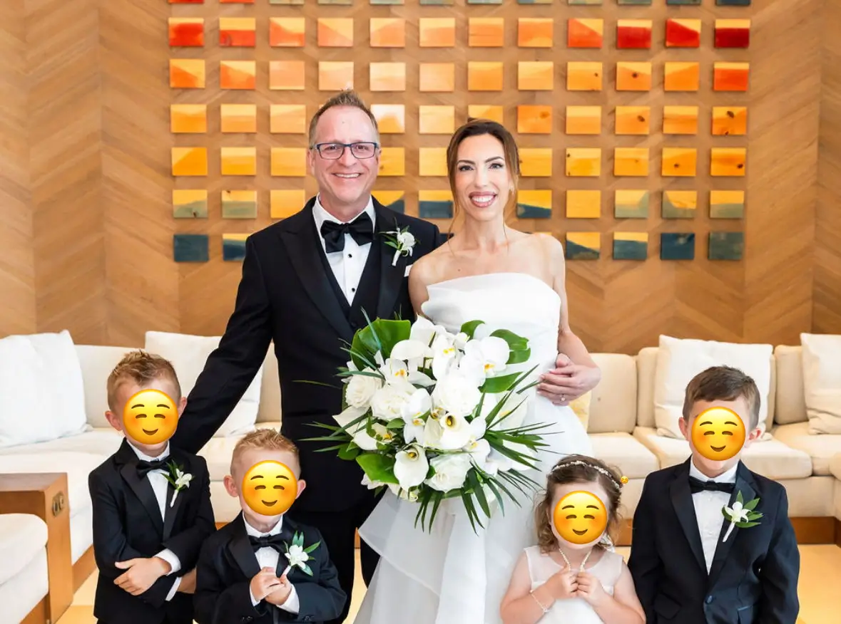 Wedding couple group photo with kids captured by a guest